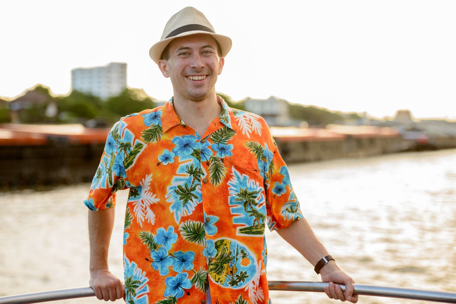 happy-young-handsome-tourist-man-at-pier-against-v-6HGMVEJ