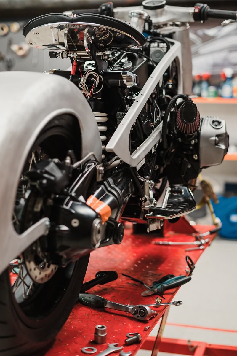 custom-motorcycle-standing-in-repair-shop-PC7HJH6