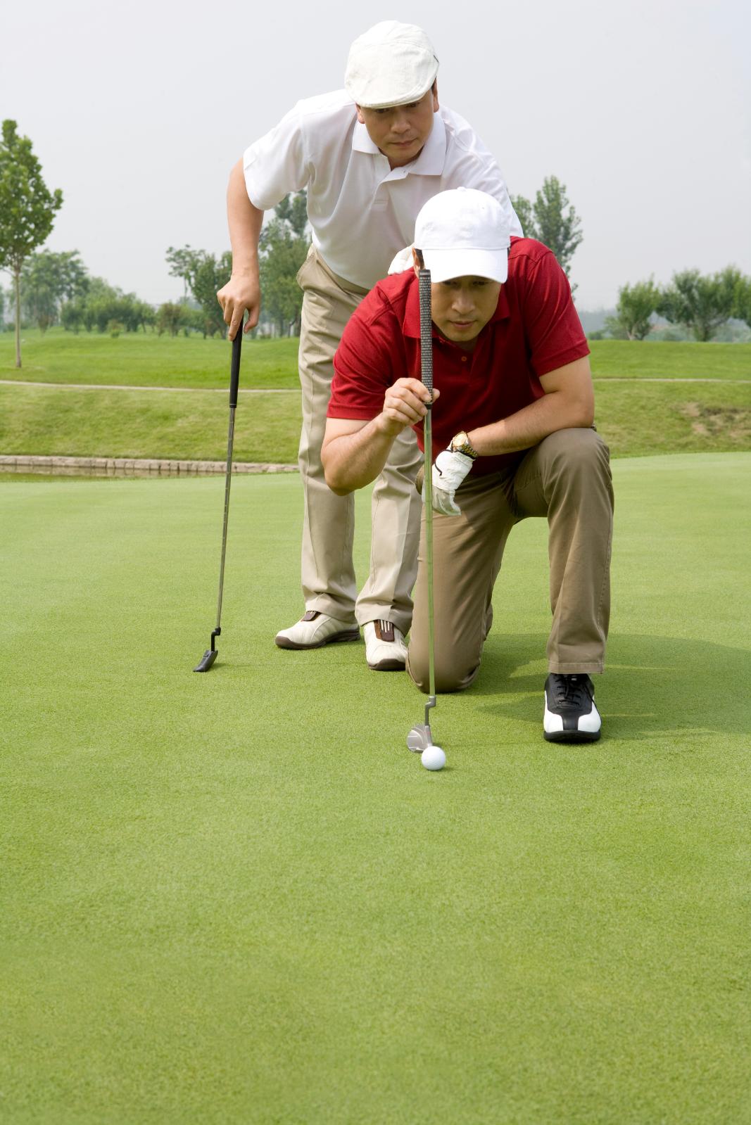 two-male-golfers-on-green-2023-11-27-05-09-44-utc