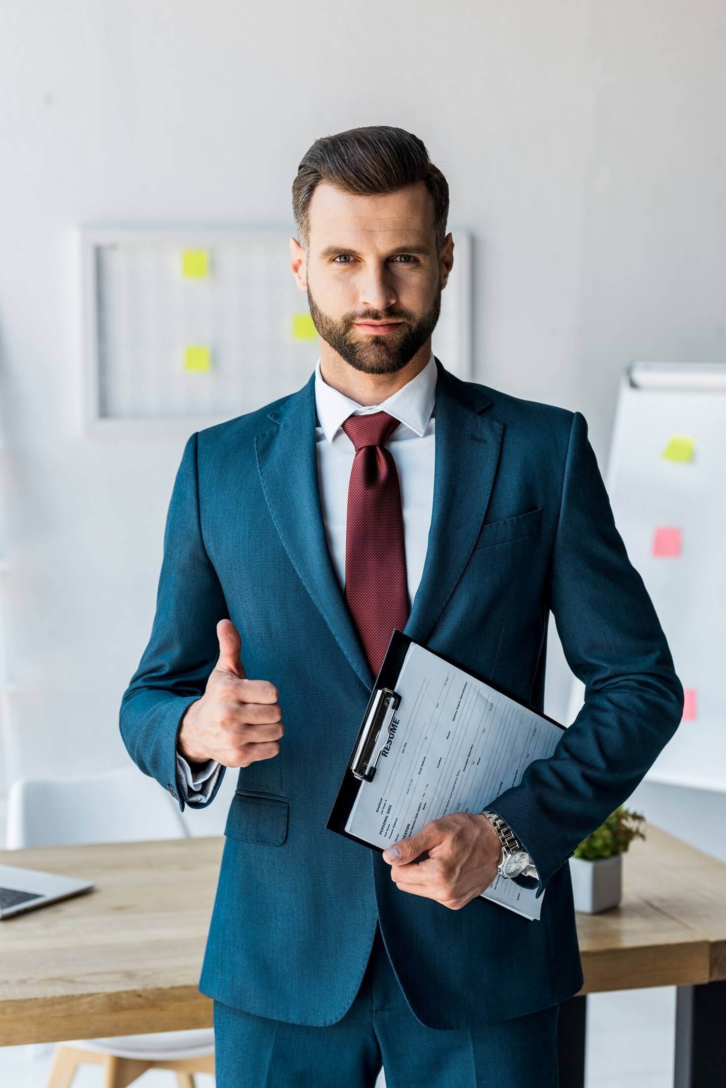 handsome-recruiter-standing-and-holding-clipboard--QRBW8R4